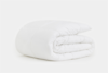 A neatly folded white comforter or duvet with a quilted pattern, displayed on a plain white background.