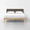 A modern wooden bed frame with a simple design, featuring a brown upholstered headboard, white bedding, and two white pillows, set against a plain white wall and floor background.
