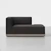 A modern, dark gray chaise lounge with clean lines, an L-shaped backrest on the left side, and a light wood base, set against a plain white background.