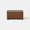A small, rectangular wooden storage box or bench with a minimalist design, placed on a light gray surface against a plain white background.