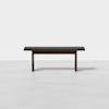 A simple, modern wooden bench with a dark finish, shown against a plain white background. The bench has straight legs and a rectangular seat.