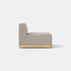 Side view of a modern, armless sofa seat with light gray upholstery and a wooden base, set against a plain white background.