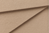 Close-up of three overlapping sheets of textured, light brown paper or cardboard arranged at an angle, creating a layered geometric pattern.