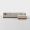A modern L-shaped sectional sofa with light beige upholstery and a low wooden base, set against a plain white background.