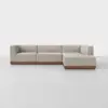 A modern L-shaped sectional sofa with light beige upholstery and a low wooden base, set against a plain white background.