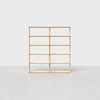 A minimalist wooden bookshelf with eight open shelves, standing on a light gray floor against a plain white background.