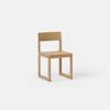 A simple wooden chair with a square seat, straight backrest, and minimalist design, placed against a plain white background.