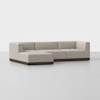 A modern L-shaped sectional sofa with light beige upholstery and a dark wood base, set against a plain white background.