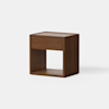 A modern wooden nightstand with a single drawer and an open shelf below, set against a plain white background. The design is minimalist with clean lines and a natural wood finish.