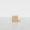 A light wood rectangular bench with clean lines and minimalist design, photographed against a plain white background, viewed from the side.