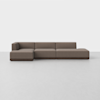 A modern, low-profile brown sectional sofa with clean lines and no visible legs, set against a plain white background on a light gray floor.