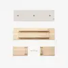 Four wooden pieces and four screws are neatly laid out on a white background, suggesting assembly of a wooden object, possibly a shelf or piece of furniture.