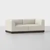 A modern, L-shaped cream-colored sofa with clean lines, plush cushions, and a dark wooden base, set against a plain white background.