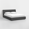A modern, low-profile bed with a dark gray upholstered frame and headboard, featuring a neatly made white mattress and two white pillows, set in a minimal white room.