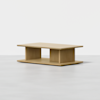 Rectangular light wood coffee table with a minimalist design, featuring a flat top, open center, and sturdy base. Set against a plain white background.