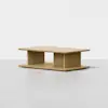 Rectangular light wood coffee table with a minimalist design, featuring a flat top, open center, and sturdy base. Set against a plain white background.