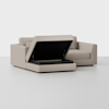 A beige upholstered storage ottoman with its cushioned lid open, revealing a spacious black interior compartment, set against a plain light background.