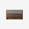 A modern wooden headboard with a rectangular, light gray cushioned panel attached along the top half, set against a plain white background.