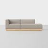 A modern, minimalist sectional sofa with light gray upholstery and a low, light wood base, set against a plain white background. The sofa has a left-arm corner and an extended chaise on the right.
