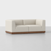 A modern, light beige sectional sofa with clean lines, low backrests, and a dark wooden base, set against a plain white background.