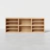 A wooden shelving unit with six open cubbies, arranged in two rows of three, each section featuring adjustable shelves. The unit is placed on a light grey floor against a white background.