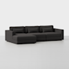 A modern, dark gray sectional sofa with a left-facing chaise lounge, three seat cushions, three back cushions, and two bolster pillows, set against a plain white background.