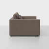 A side view of a modern, boxy brown sofa with clean lines and two back cushions, set against a plain white background.