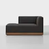 A modern black chaise lounge with a low wooden base, featuring a right-arm backrest and clean, minimalist lines, set against a plain white background.