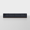 A low-profile, dark grey modular sectional sofa with a dark wood base is centered against a plain white background.