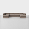 A large, modern, L-shaped sectional sofa with brown upholstery sits on a light gray floor against a plain white wall.