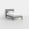 A minimalist single bed with a light wooden frame, light gray upholstered headboard, and white bedding with a single pillow, placed in a plain, empty room with white walls and floor.