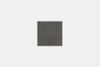 A neatly folded, dark gray rectangular towel is centered on a plain, light gray background.