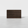 A modern, dark brown wooden dresser with six drawers stands on a light gray floor against a plain white background.