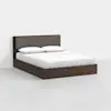 A modern wooden bed frame with a dark finish, featuring a padded fabric headboard. The bed is neatly made with white bedding and two pillows, set against a plain white background.