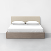 A minimalist bed with a light beige upholstered headboard, white bedding, and two pillows, set on a light wood platform against a plain white wall and gray floor.