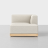 A modern, light beige upholstered sofa with a wooden base, featuring a right-armrest and a low-profile backrest, shown against a plain white background.