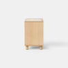 A minimalist wooden nightstand with four short legs, a single open drawer, and an open storage space beneath it, set against a plain white background.