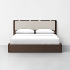 A modern bed with a dark wooden frame and a light-colored upholstered headboard, neatly made with white bedding and two white pillows, positioned against a plain white wall.