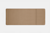 A rectangular, tan leather desk pad with rounded corners and a stitched border, featuring a smaller, attached section on the right side. The background is plain white.