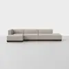 A modern, modular beige sectional sofa with clean lines and low backrests, set on a dark wooden base, placed in a minimalist setting with a plain white background.