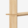 Close-up of a wooden shelf joint, showing a smooth, light wood texture and clean, precise construction details against a plain white background.