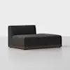 A modern, dark gray chaise lounge with a low, solid wood base and a single backrest on the left side, set against a plain light background.