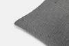 A close-up of a gray textured pillow with a soft, crinkled fabric surface, shown against a plain white background.