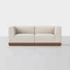 A modern, minimalist loveseat with light beige upholstery and a rectangular wooden base, set against a plain white background.