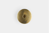A round, bronze-colored metal object with a slightly raised center, set against a plain white background.
