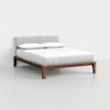 A modern bed with a light gray upholstered headboard, white bedding, and a wooden frame, set against a plain white background. Two white pillows are placed at the head of the neatly made bed.