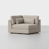 A modern, light beige upholstered corner chair with square arms and three matching cushions, set against a plain white background.