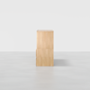 A light wood rectangular cabinet with clean lines, viewed from the side against a plain white background. The cabinet has three visible sections and a smooth, minimalistic design.