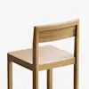 A simple wooden chair with a straight backrest and square seat, shown at an angle against a plain white background.