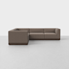 A modern, L-shaped sectional sofa with brown upholstery and a dark wooden base, set against a plain white background on a light grey floor.